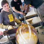 Penland instructor Martin Janecky and his students making a large blown glass piece in the glass studio