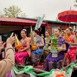 Following a small parade around the grounds of Wat Lao Sayaphoum, the young girls dressed as princesses pose for photos and receive gifts at Pii Mai.